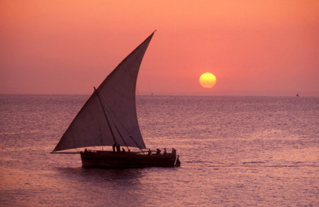 a traditional Dhoni Sailboat at the Indian Ocean in front of the Old Town of Stone Town on the Island of Zanzibar in Tanzania.  Tanzania, Zanzibar, Stone Town, October, 2004のeditorial素材