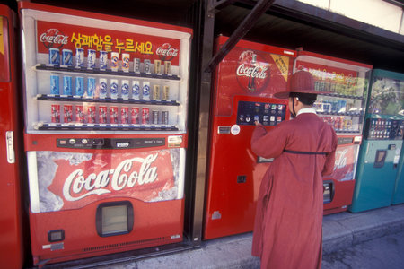 a histoirc dresst men at a drinks automat in the city of Seoul in South Korea in EastAasia. ...