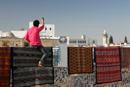 a Carpet Shop and Production in front of a old Mosque in the Medina of the Old City of Tunis in north of Tunisia in North Africa,  Tunisia, Sidi Bou Sair, March, 2009のeditorial素材