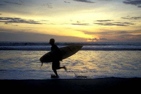 Surfer on the Nusa Dua Beach near Nusa Dua Town in the south of Island Bali in Indonesia.  Indonesia, Bali, March, 5, 2001のeditorial素材