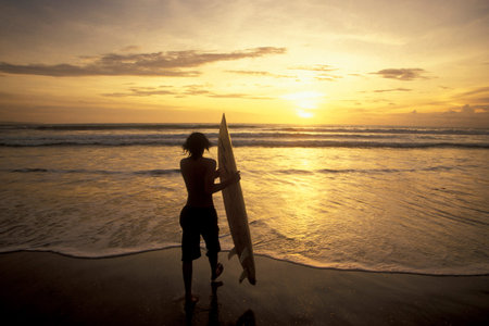 Surfer on the Nusa Dua Beach near Nusa Dua Town in the south of Island Bali in Indonesia. ...