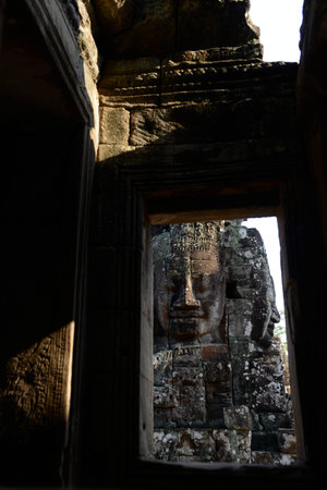 Stone face at the Bayon Temple the Tempel Ruins of Angkor Thom in the Temple City of Angkor near the City of Siem Reap in the west of Cambodia.  Cambodia, Siem Reap, April 2014のeditorial素材