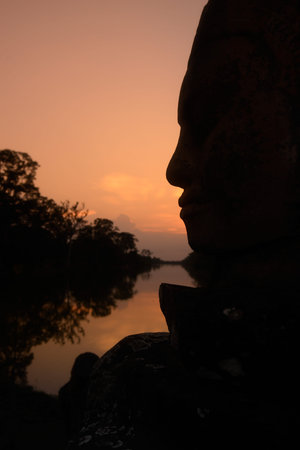stone face at the Bridge of the south gate to the Angkor Tom city in the Temple City of Angkor near...