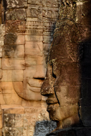 Stone face at the Bayon Temple the Tempel Ruins of Angkor Thom in the Temple City of Angkor near the City of Siem Reap in the west of Cambodia.  Cambodia, Siem Reap, April 2014のeditorial素材