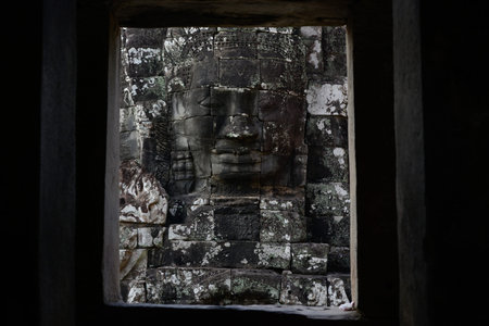 Stone face at the Bayon Temple the Tempel Ruins of Angkor Thom in the Temple City of Angkor near the City of Siem Reap in the west of Cambodia.  Cambodia, Siem Reap, April 2014のeditorial素材