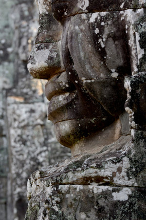 Stone face at the Bayon Temple the Tempel Ruins of Angkor Thom in the Temple City of Angkor near the City of Siem Reap in the west of Cambodia.  Cambodia, Siem Reap, April 2014のeditorial素材