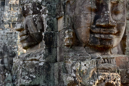 Stone face at the Bayon Temple the Tempel Ruins of Angkor Thom in the Temple City of Angkor near the City of Siem Reap in the west of Cambodia.  Cambodia, Siem Reap, April 2014のeditorial素材