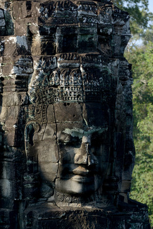 Stone face at the Bayon Temple the Tempel Ruins of Angkor Thom in the Temple City of Angkor near the City of Siem Reap in the west of Cambodia.  Cambodia, Siem Reap, April 2014のeditorial素材