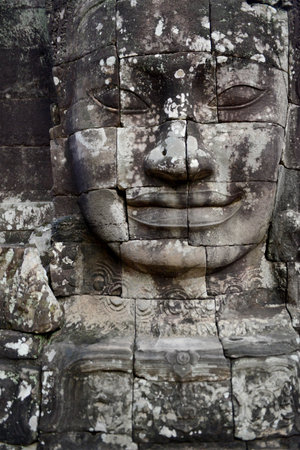 Stone face at the Bayon Temple the Tempel Ruins of Angkor Thom in the Temple City of Angkor near the City of Siem Reap in the west of Cambodia.  Cambodia, Siem Reap, April 2014のeditorial素材