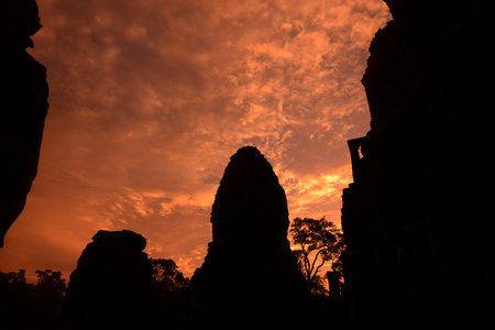 sunset at the Bayon Temple the Tempel Ruins of Angkor Thom in the Temple City of Angkor near the City of Siem Reap in the west of Cambodia.  Cambodia, Siem Reap, April 2014のeditorial素材