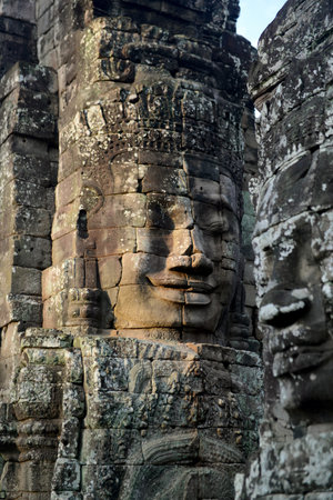 Stone face at the Bayon Temple the Tempel Ruins of Angkor Thom in the Temple City of Angkor near the City of Siem Reap in the west of Cambodia.  Cambodia, Siem Reap, April 2014のeditorial素材