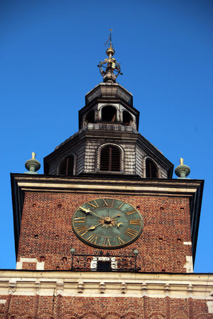 the city hall tower at the  Rynek Glowny square in the old town of Cracow in Poland in east Europe.