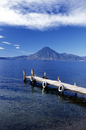 The Lake Atitlan mit the Volcanos of Toliman and San Pedro in the back at the Town of Panajachel in Guatemala in central America.のeditorial素材