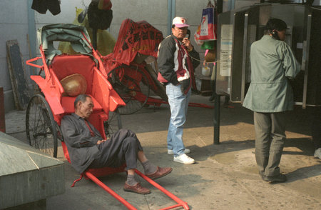 A traditional Hand and walking Rickshaw in Kowloon in the city of Hongkong in Hongkong.  China,...