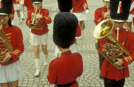 Young people in a traditional red British Royal Uniform on a Event in Kowloon in the city of...