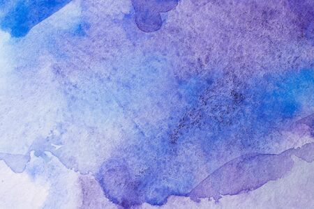 Abstract Hand painted blue purple watercolor background on wet paper, texture for creative wallpaper or design artwork.の写真素材