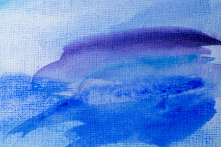 Abstract Hand painted blue purple watercolor background on wet paper, texture for creative wallpaper or design artwork.の写真素材