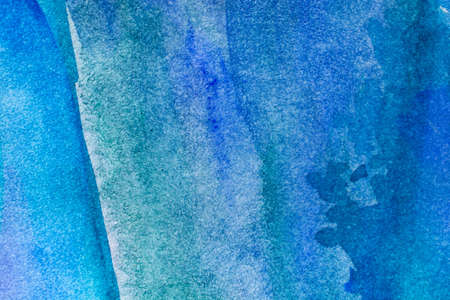 Abstract blue watercolor background with different layers on paper textureの写真素材