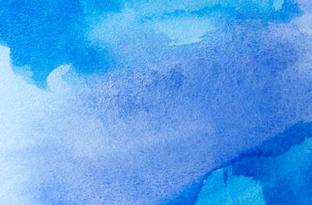 Abstract blue watercolor background with different layers on paper textureの写真素材