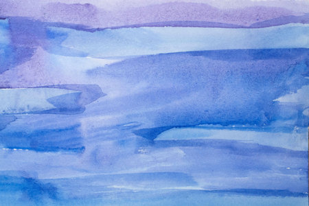 Abstract Hand painted blue purple watercolor background on wet paper, texture for creative wallpaper or design artwork.の写真素材