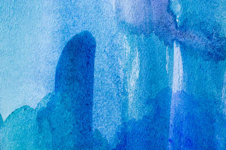 Abstract blue watercolor background with different layers on paper textureの写真素材