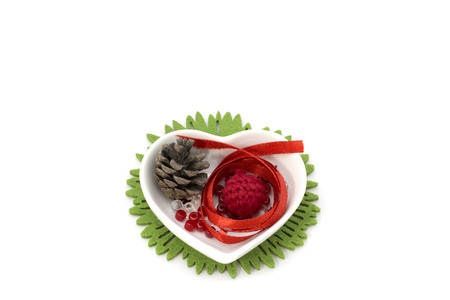 Picture with red ribbon, heart shape small bowl and decorationsの写真素材