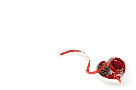 Picture with red ribbon, heart shape small bowl and decorationsの写真素材