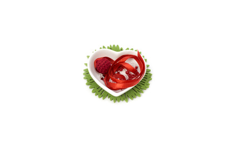 Picture with red ribbon, heart shape small bowl and decorationsの写真素材