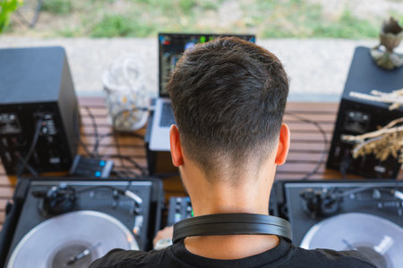 Overhead view of a DJ and mixing console during a private partyの写真素材