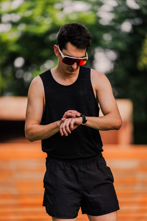 Close-up shot of a professional athlete checking the smartwatch during a training session