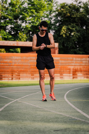 Professional athlete monitoring his heart rate with his smartwatch during a training session