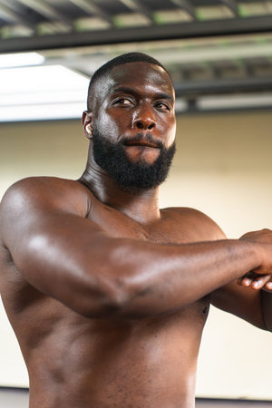 Black man with athletic body getting ready before workoutの写真素材