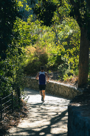 unrecognizable caucasian man running in the parkの写真素材