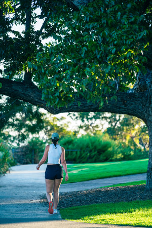 unrecognizable caucasian woman walking in the parkの写真素材