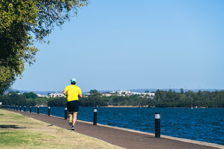 adult man running along the coastの写真素材