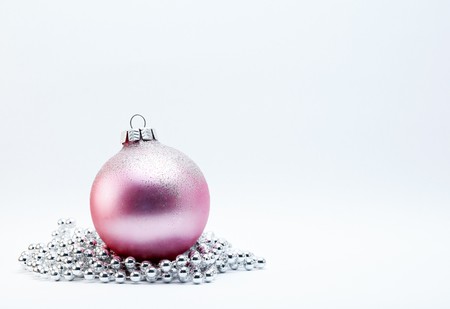 Pink Christmas Bauble with silver beads on a white background.の写真素材