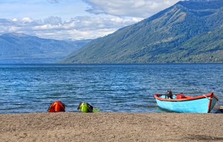 Boats resting on the shore of a lake on the outskirts of Pucon, Chile の写真素材