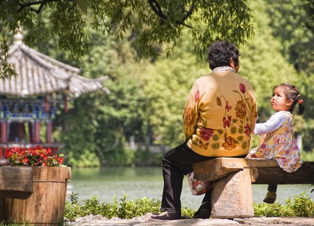Young Chinese girl with her Grand mother in Jade Spring Park, Lijiang, China, July 10 2010.のeditorial素材