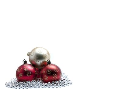 Gold christmas bauble on three red baubles with glitter on silver beadsの写真素材