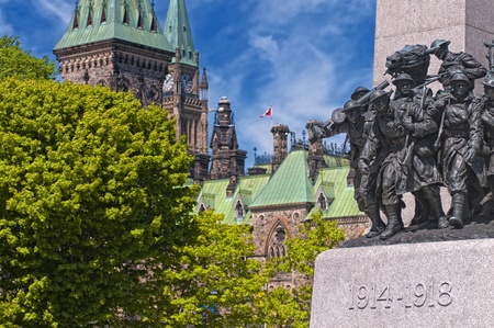 The National War Memorial in Ottawa, Canada with Parliament Hill in the background.の写真素材
