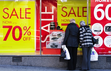 Shoppers browse the highstreet windows or bargains during the Janruary sales with discounts up to 70%. Sheffield, England, Janruary 12 2012.のeditorial素材