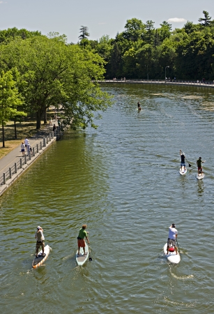 Paddlers take part in the Stand Up For CHEO (SUFC) 18km group paddle along the historic Rideau Canal in Ottawa, Ontario. July 8 2012. Stand Up For CHEO is a non-profit fundraising event for the Children's Hospital of Eastern Ontario (CHEO). のeditorial素材