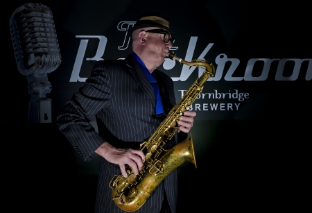Musician Bob Swift playing the tenor saxophone during a gig at the Greystones with his four-piece rhythm & blues band のeditorial素材