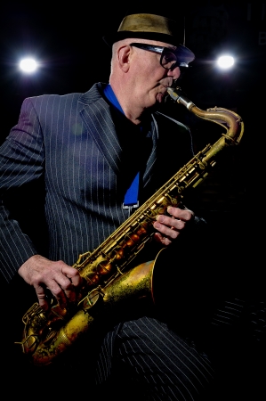 Musician Bob Swift playing the tenor saxophone during a gig at the Greystones with his four-piece rhythm & blues band のeditorial素材