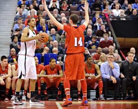 OTTAWA - MARCH 9: Thomas Scrubb (left) in action for the Carleton Ravens in their match against Acadia Axemen at Scotiabank Place, Ottawa on March 9 2013 during the 2013 Men's CIS basketball Finals.のeditorial素材
