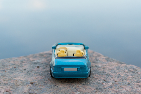 Close up image of blue convertible car standing on the edge of roadの写真素材