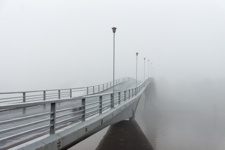 Perspective view of a bridge on a foggy morningの写真素材