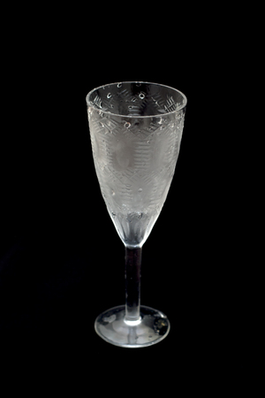 Close up image of empty crystal wineglass against black backgroundの写真素材
