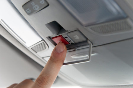 Close up image of car driver pushing emergency button
