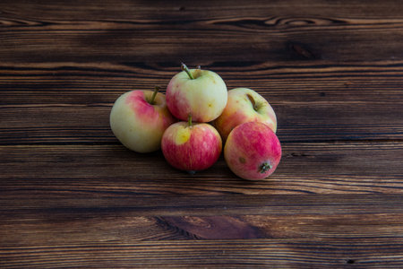 A few ripe apples on a wooden table.の写真素材